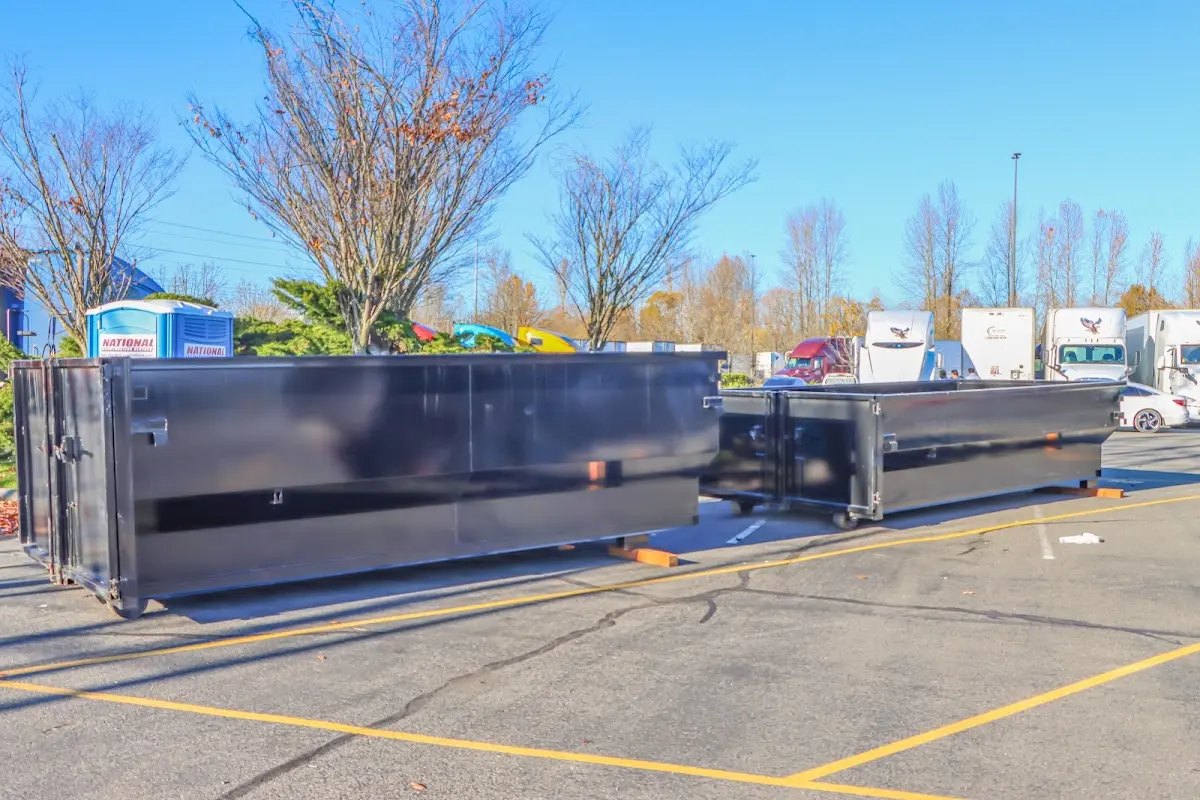 Professional dumpster rental service with roll-off container on residential driveway in Tifton